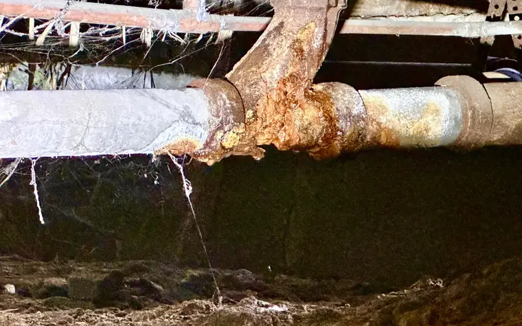 Corroded pipe in a crawlspace