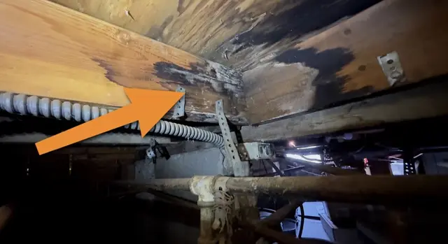 Moisture stains on wood framing in a crawlspace